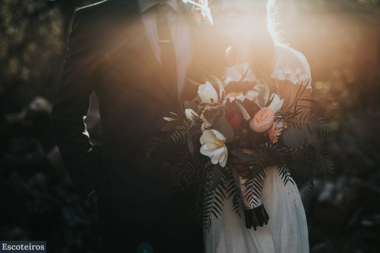 groom beside bride holding bouquet flowers